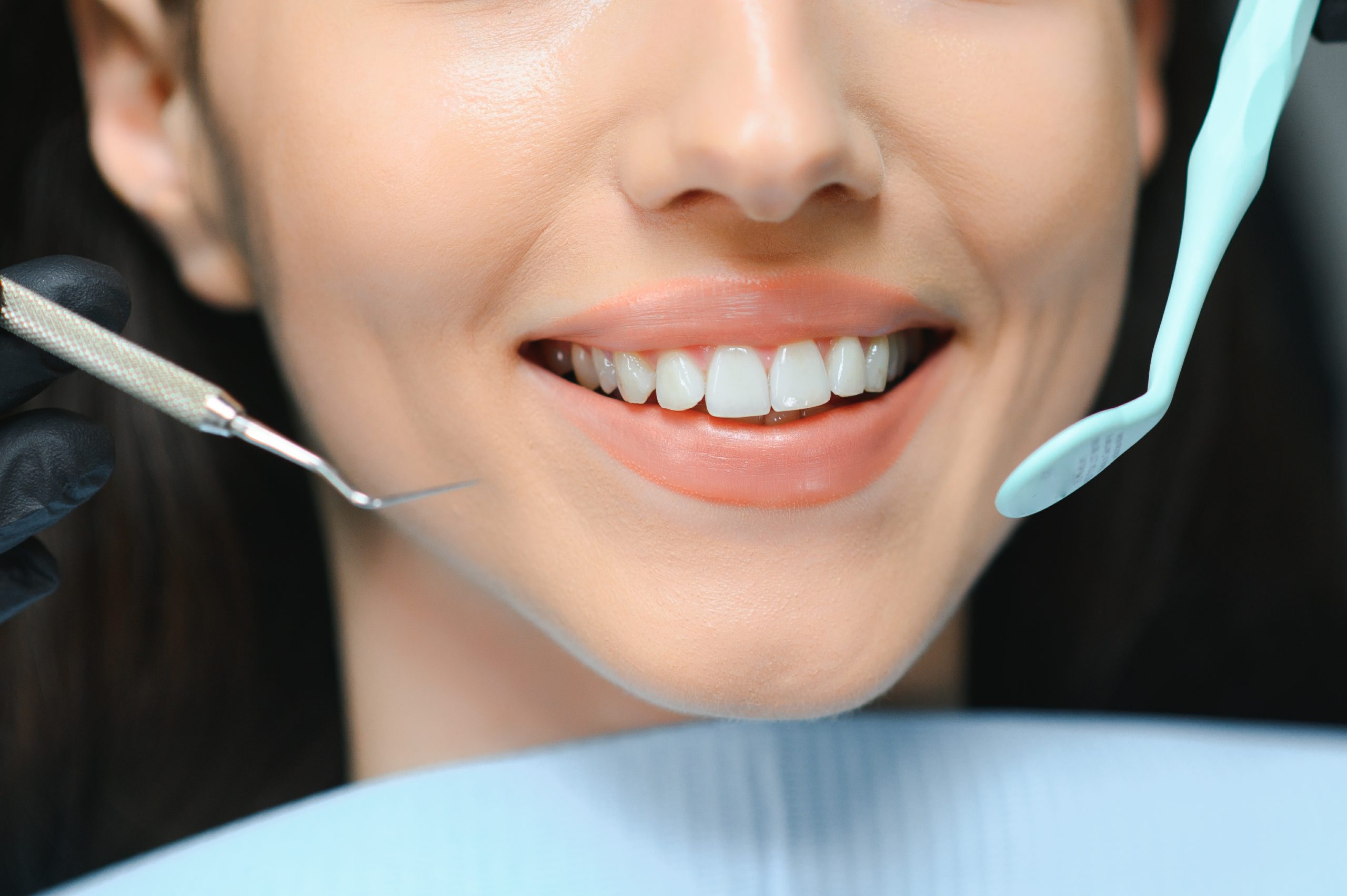 Patient smiling while getting dental crowns with Dentaventures
